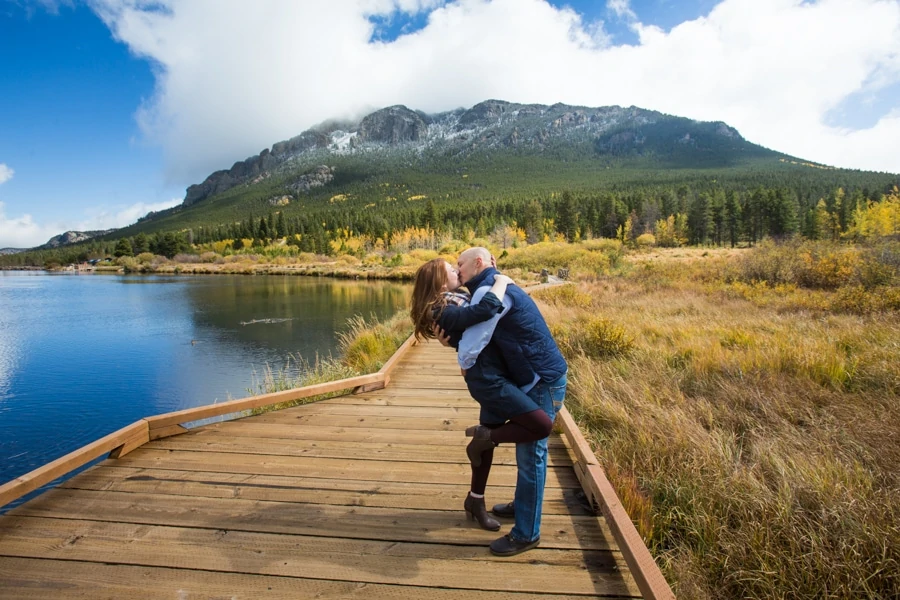 An engagement photo on the boardwalk at Lily Lake in Rocky Mountain National Park.