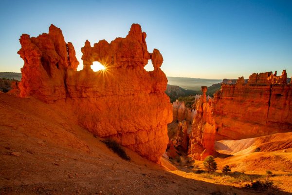 A colorful photograph of Bryce canyon at sunrise