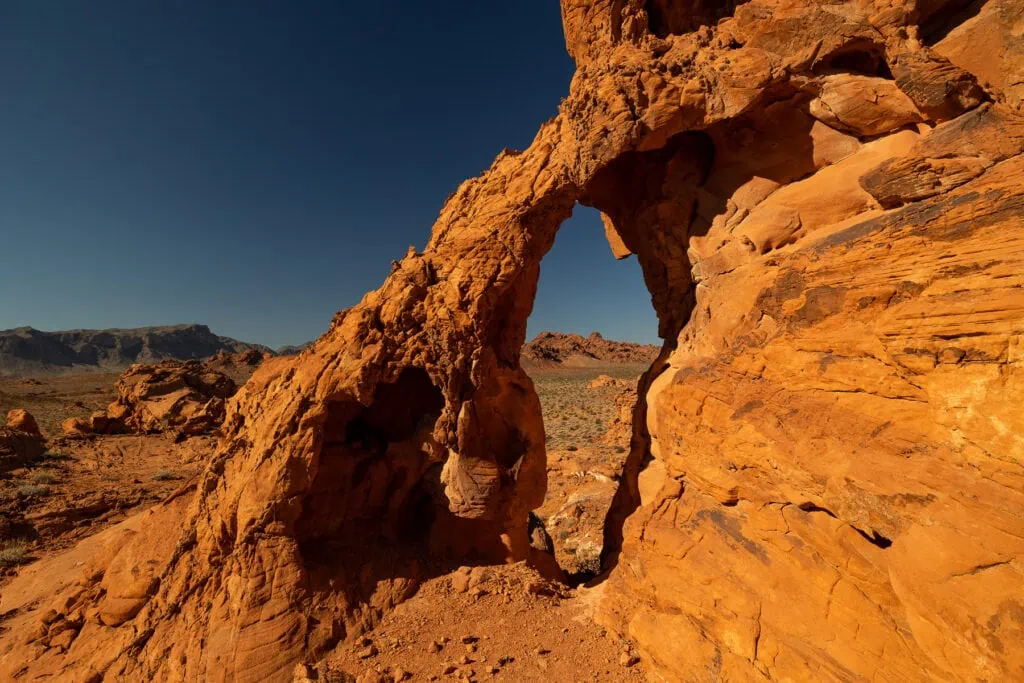 A 15 foot stone arch made out of orange rock in Valley of Fire makes it a unique elopement location in the us.