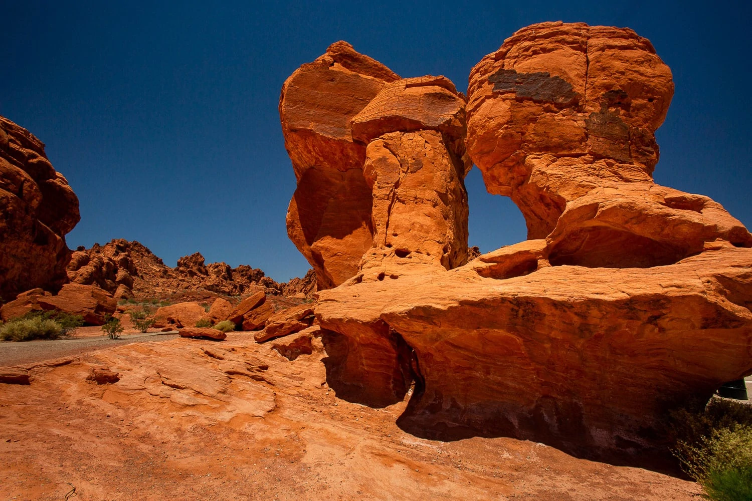 Colorful red rock formations set against a blue sky.