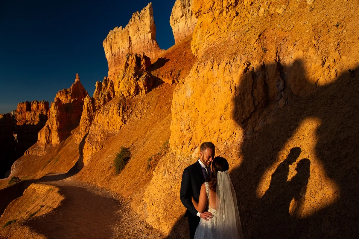 A wedding couple walks through the amphitheater at Bryce Canyon National Park.