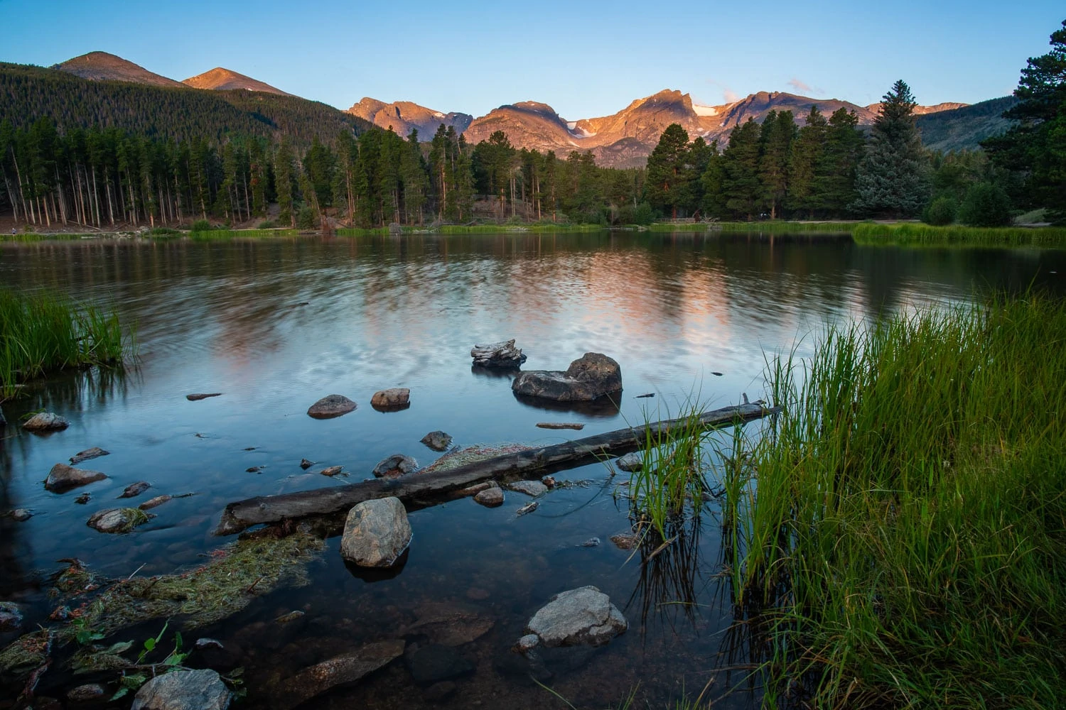 Sprague lake at sunrise in the summer by Rocky Mountain National Park photographer Lucy Schultz.