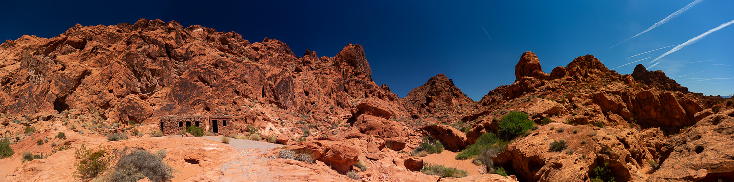 a panoramic image of the historic cabins set against red sandstone cliffs in Valley of fire state park.
