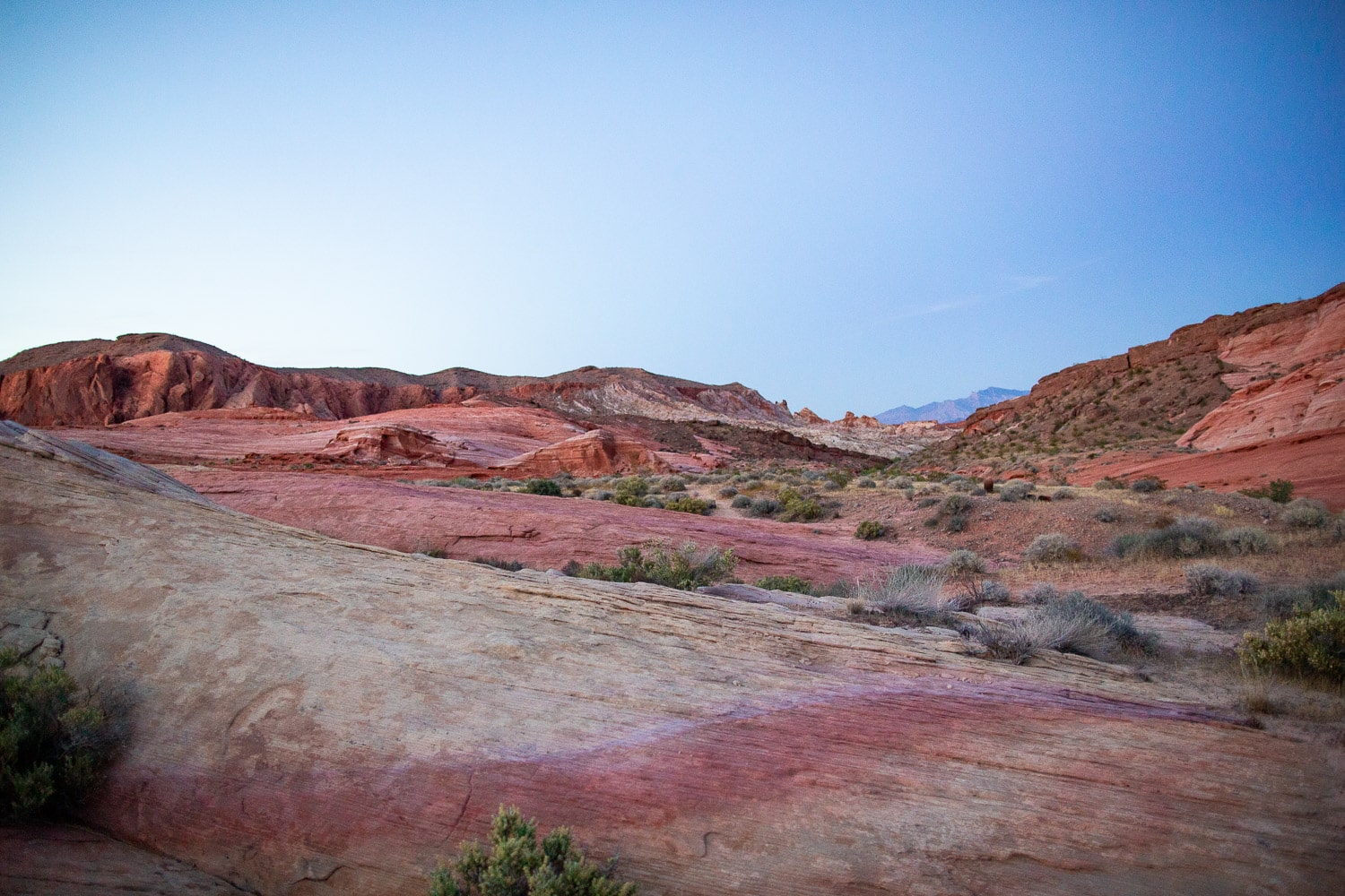 Layers of pink, white, and orange rock in the desert.