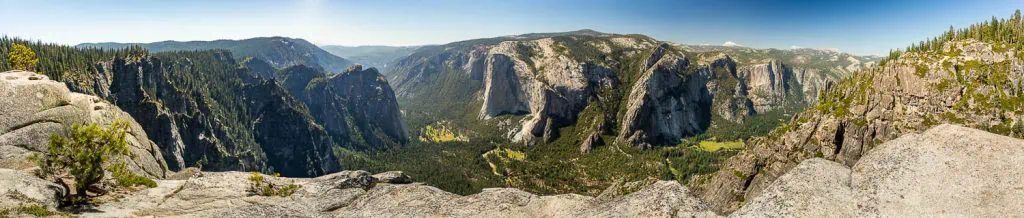 Glacier point in summer with green foliage in the foreground by Yosemite photographer Lucy schultz.