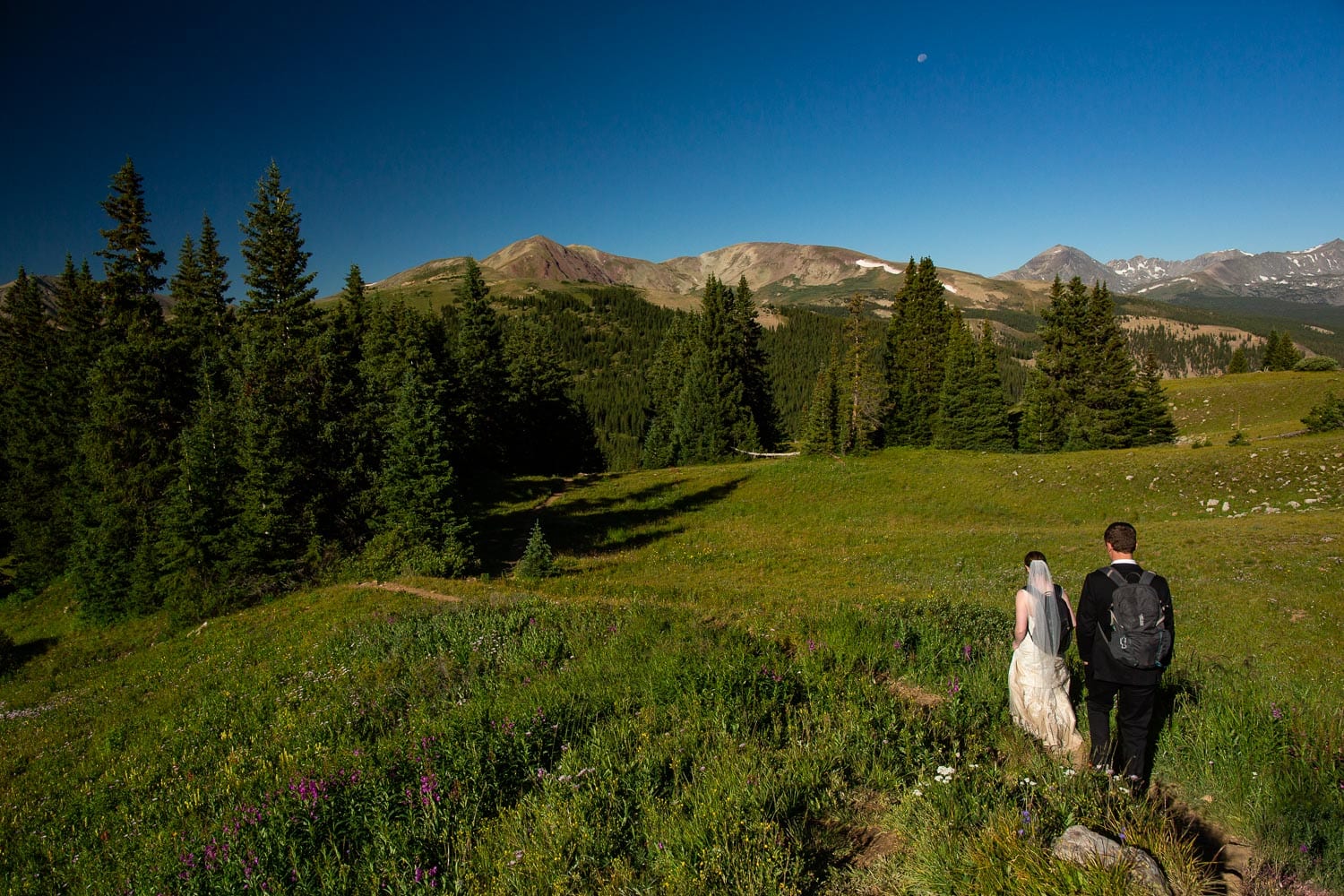 A couple hikes to their elopement spot in the colorado mountains.