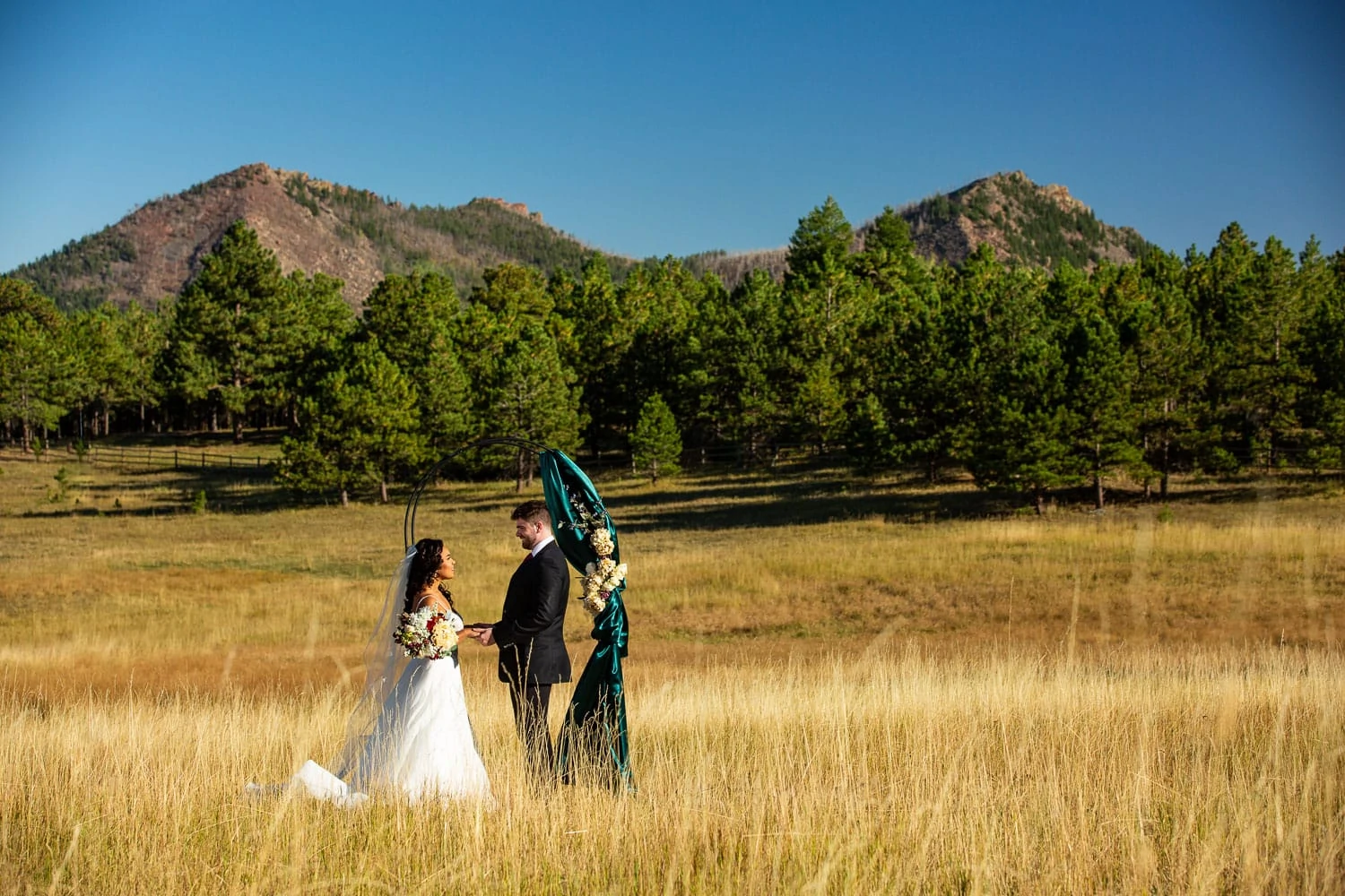 An interracial couple says their private vows in front of the mountains in Boulder, Colorado.