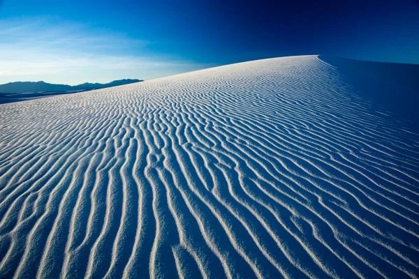 A dramatic view of a White Sands dune as a potential elopement location with Lucy Schultz Photography as a guide.