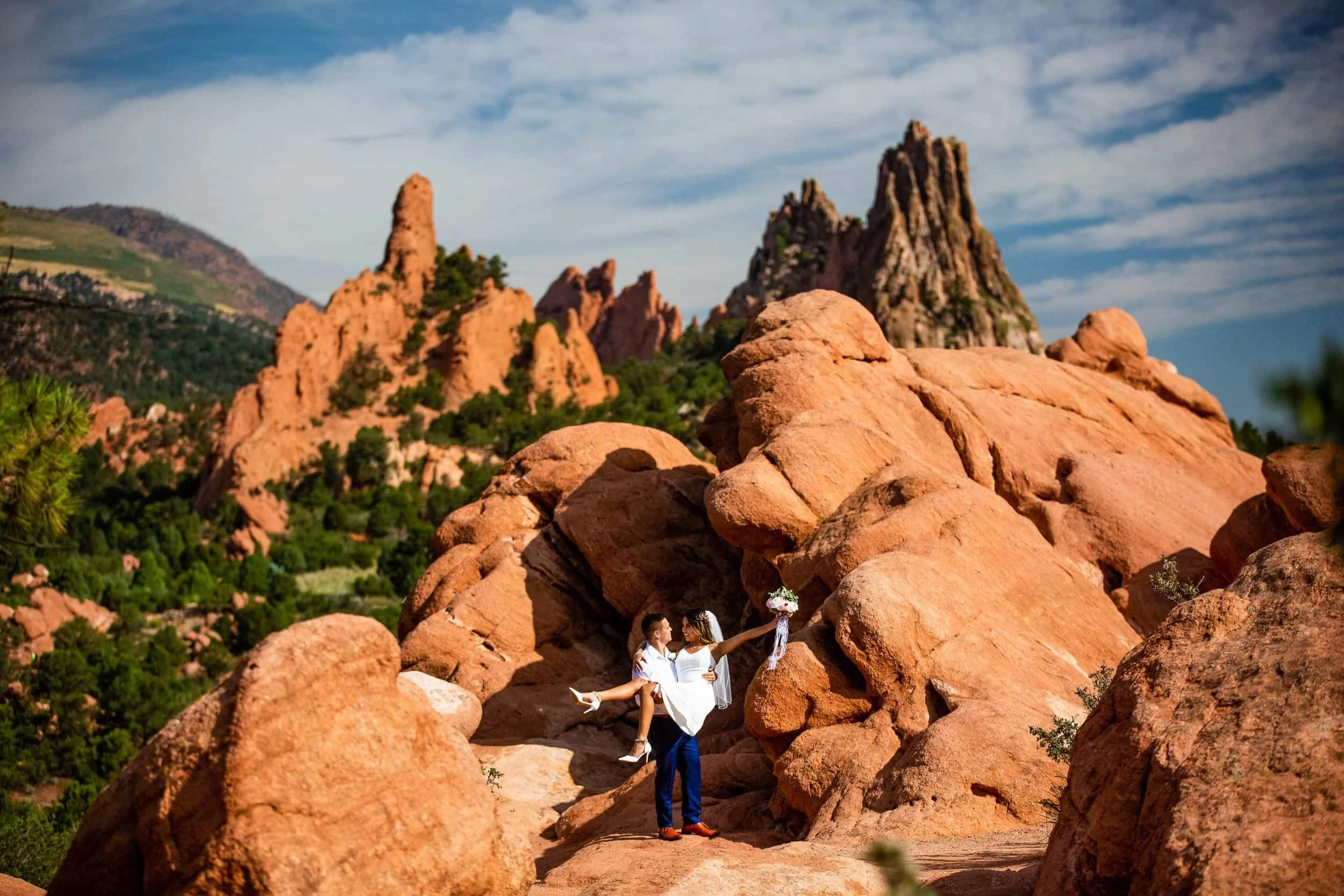a man picks up his bride at their elopement at Garden of the Gods