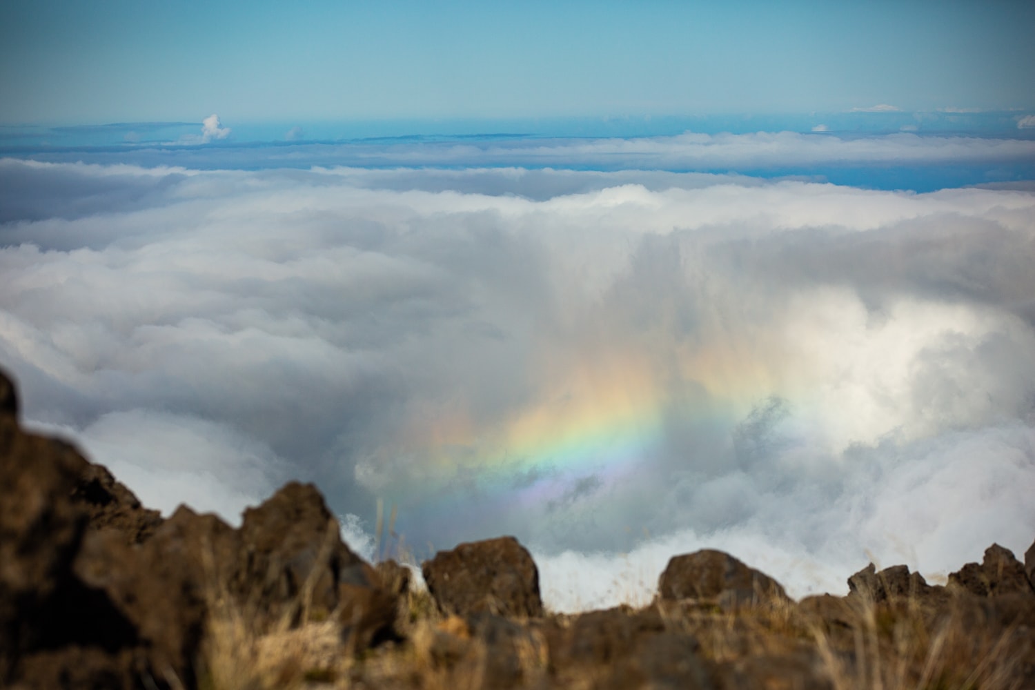 A rainbow above the clouds from Haleakala summit.