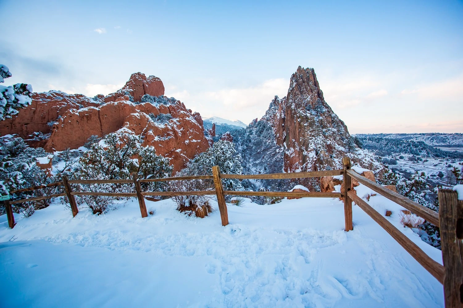 A valley between two red rock formations at Garden of the Gods in winter time.