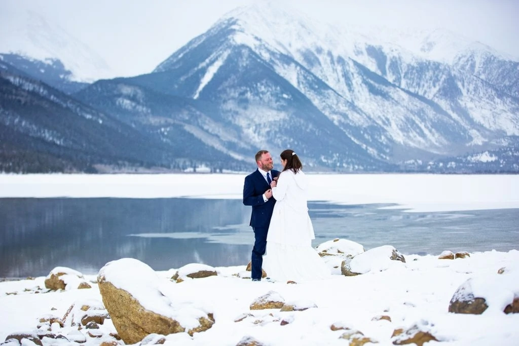 A december elopement at Twin Lakes in Central Colorado with a huge mountain in the background and a blanket of snow.