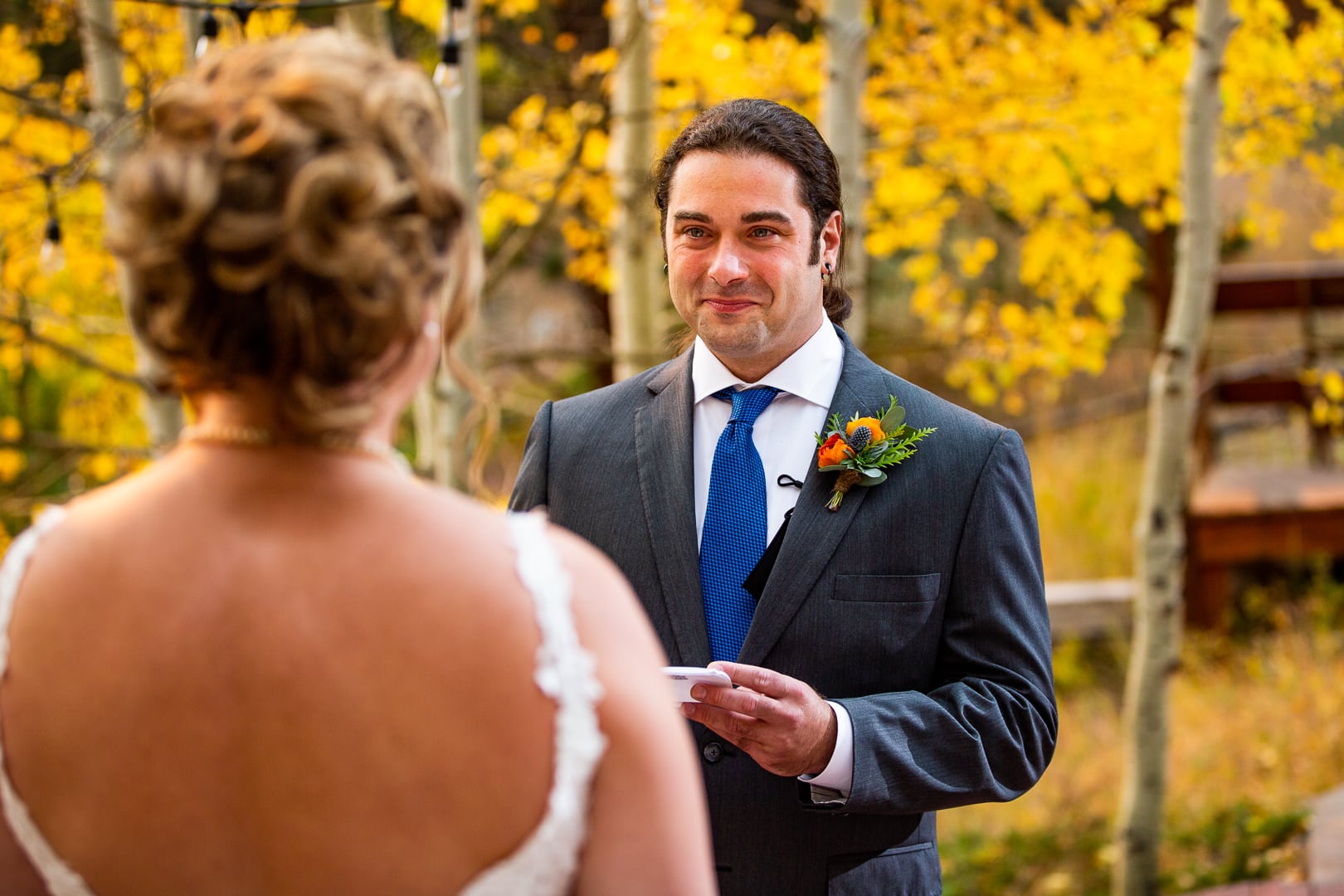 A groom reads his hand written vows at their colorado elopement ceremony.
