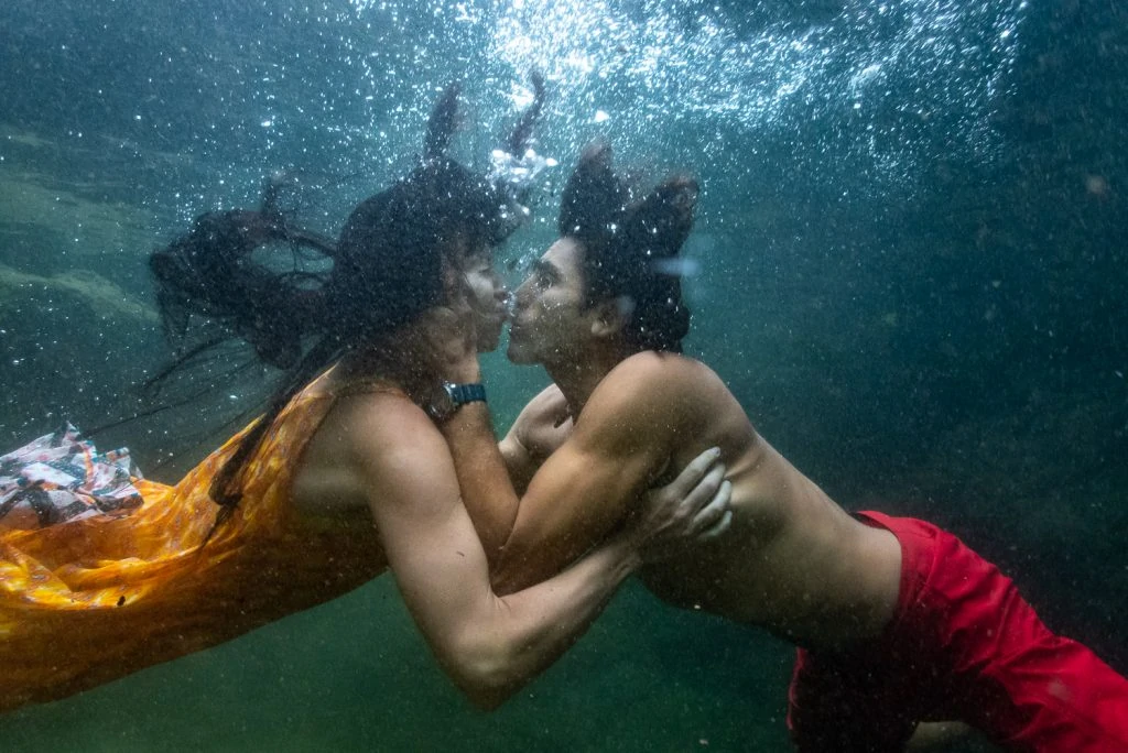 An underwater photo of a just married couple after diving beneath a waterfall in Costa Rica.