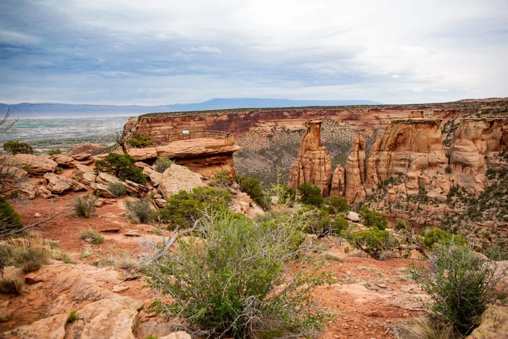 The view from Grand View point of the Colorado National Monument with its desert brush vegetation, dramatic canyon and rock spires.