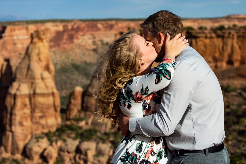 A tear rolls down the brides cheek as she kisses the groom at their colorado national monument elopement photoshoot.