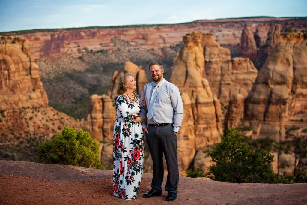 An elopement couple looks majestic in front of Independence monument in Colorado National Monument.