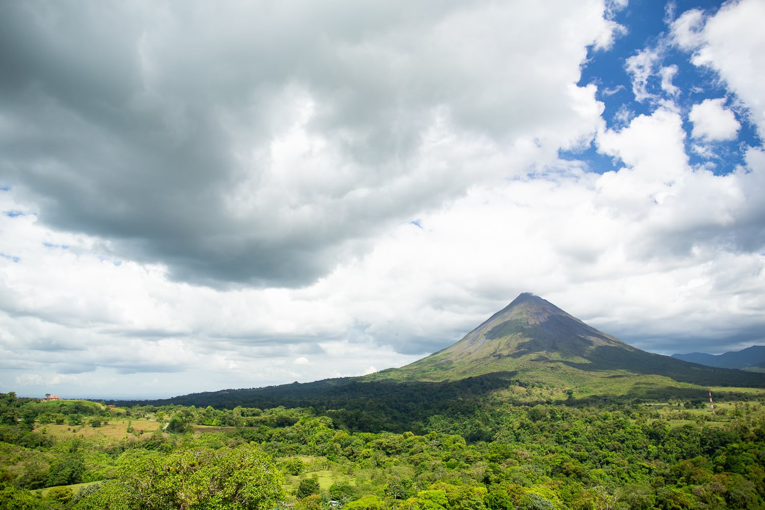 Arenal Volcano dominates the skyline of the tropical town of La Fortuna, Costa Rica.