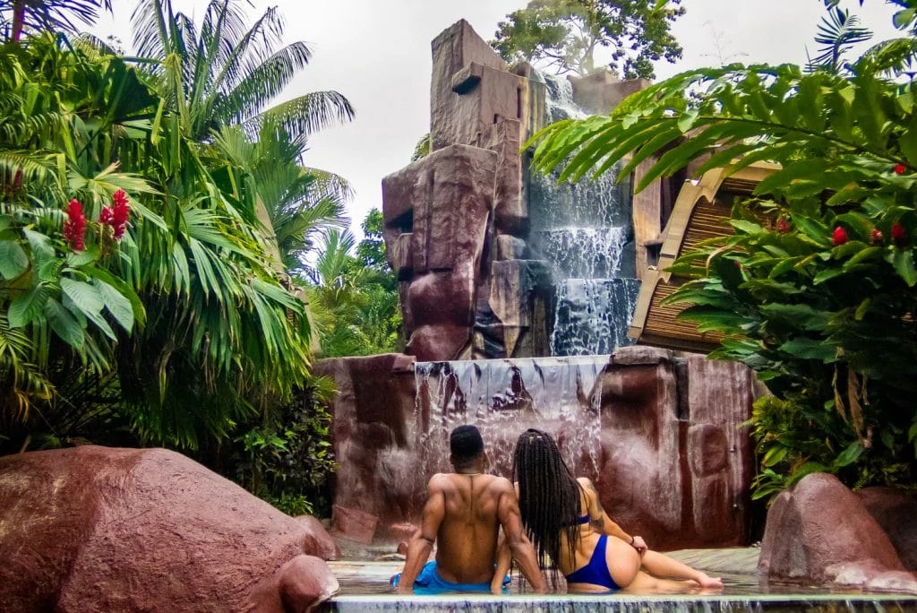 A black couple enjoying a hot springs fountain in Costa Rica.