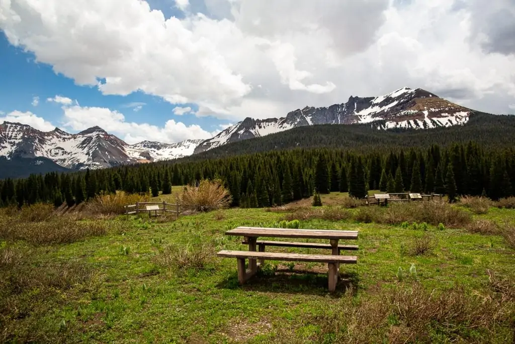 A few picnic tables in front of the San Juan mountains in Telluride, Colorado offers an option for an outdoor intimate wedding reception with great views.