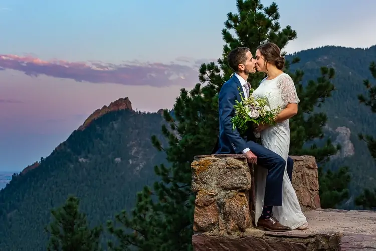 An elopement couple kiss at Sunrise Amphitheater in Boulder, CO.