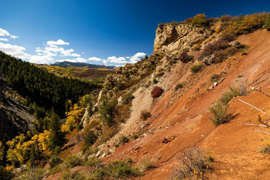 A sunny day over the colorful Red Butte in Aspen, Colorado makes a good elopement location.