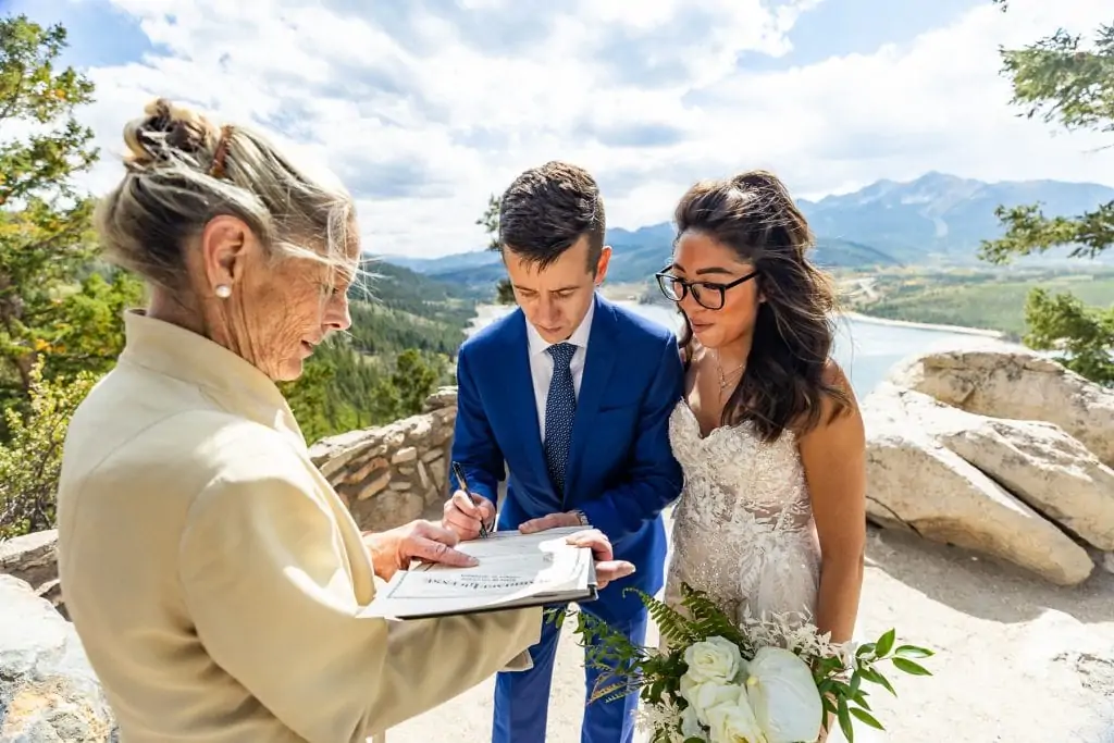 An elopement couple signs their marriage license in Colorado.