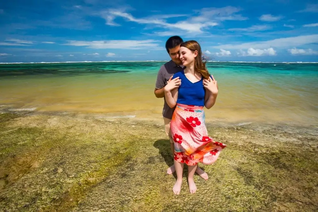 An interracial couples portrait on a colorful beach in Bali.
