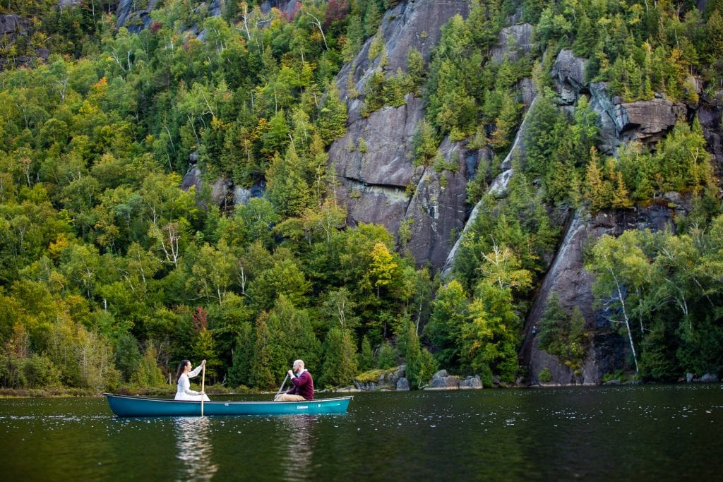 A photo of an elopement couple in a canoe on a lake.