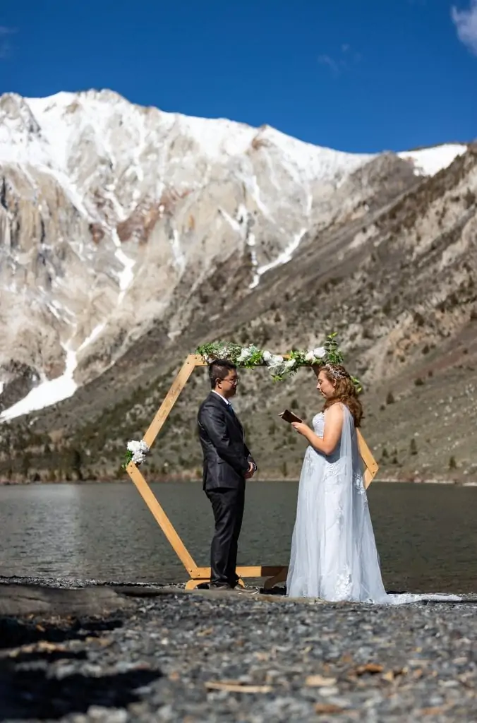 An eloping couple reads their vows at convict lake in Mammoth, California