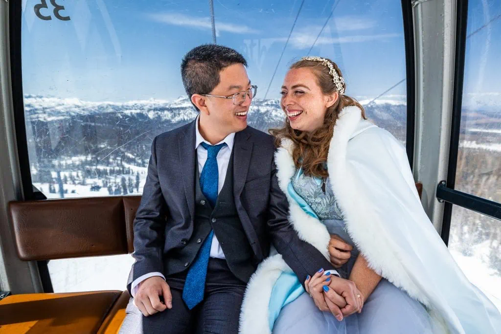 A newlywed couple rides the Mammoth Mountain gondola.