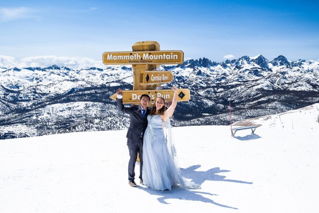A wedding couple at the summit of Mammoth Mountain in winter.