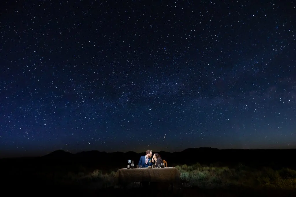 Newlyweds stargaze at their campsite during their camping elopement.