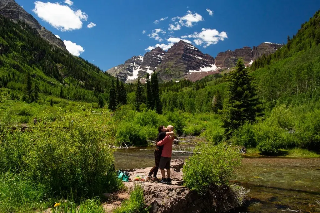 A colorful photo of a couple's engagement in Aspen Colorado at the Maroon Bells.