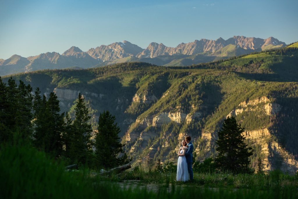 Portrait of the newlyweds at their Vail Colorado elopement with mountains in the background.