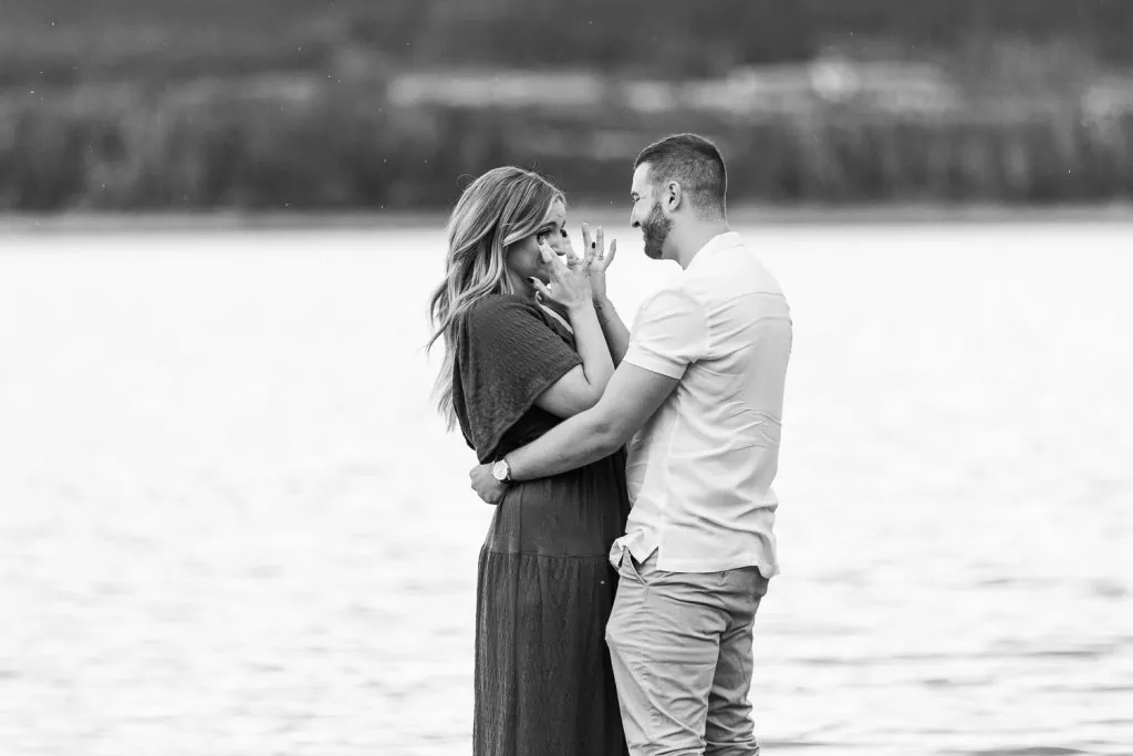 A woman is emotional after her proposal in breckenridge at a lake.