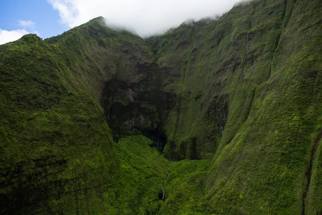 Wai'ale'ale, the wettest place on Kauai, is a steep mountain wall with waterfalls running down it.