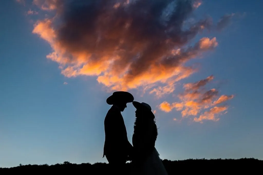 A yosemite elopement couple in silhouette with cowboy hats.