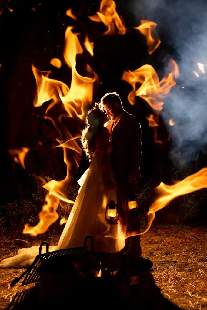 The elopement couple's first dance surrounded by campfire.