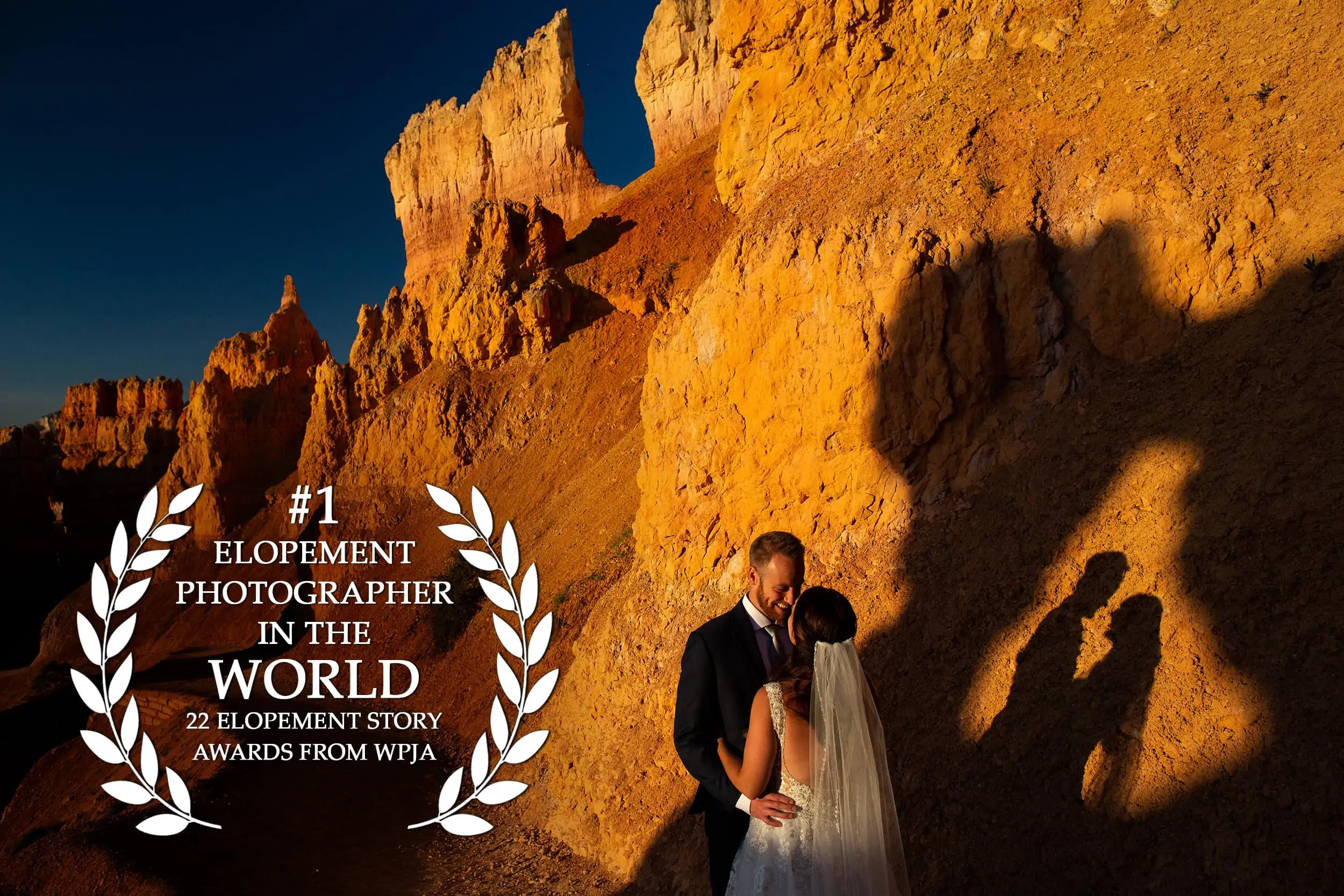 A photo of an elopement couple in a  desert national park, with their silhouettes on the rock next to them, and the text "#1 elopement photographer in the world, 22 elopement story awards from WPJA" superimposed on the left of the image.