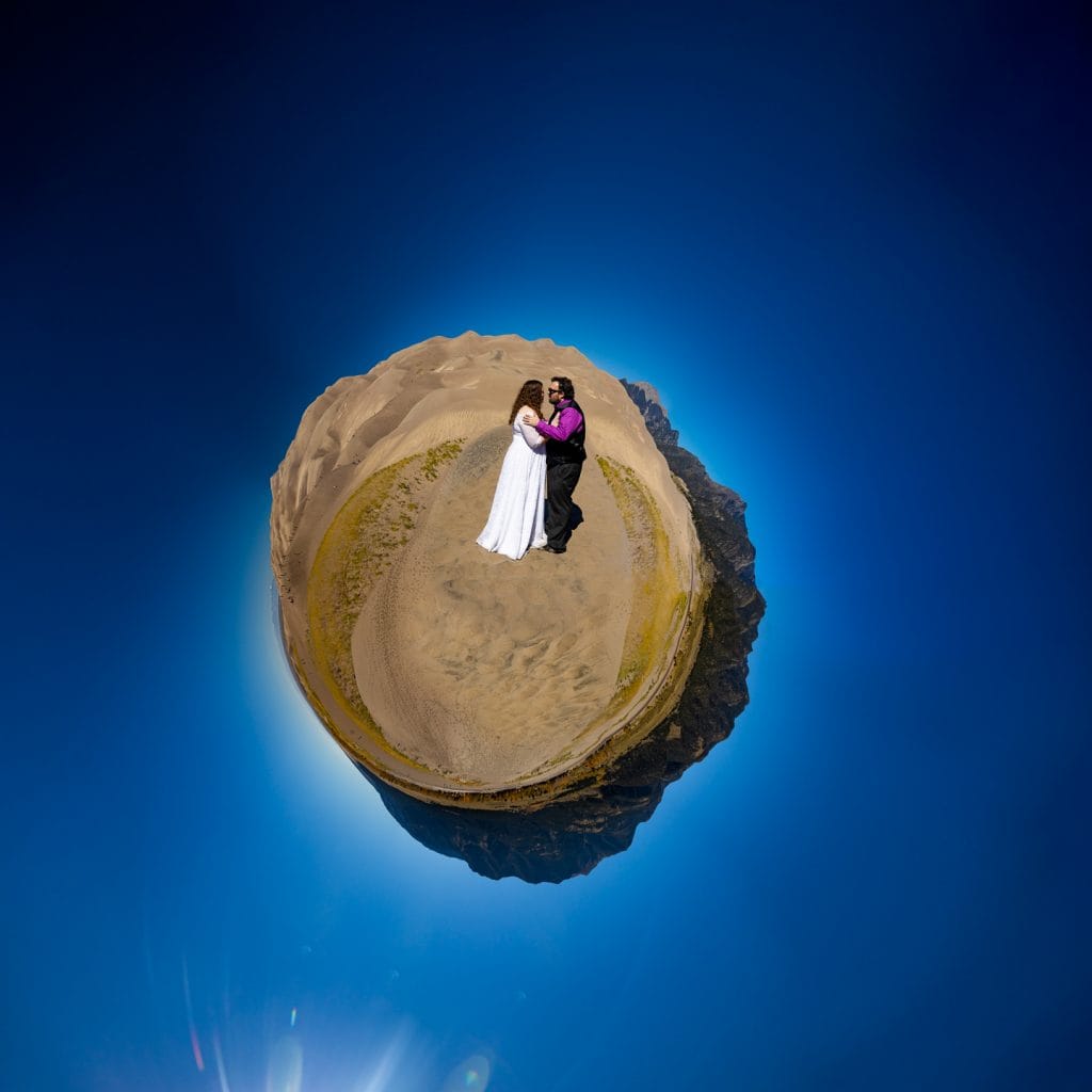 A 360 degree photo of the great sand dunes with a wedding couple in the middle. 