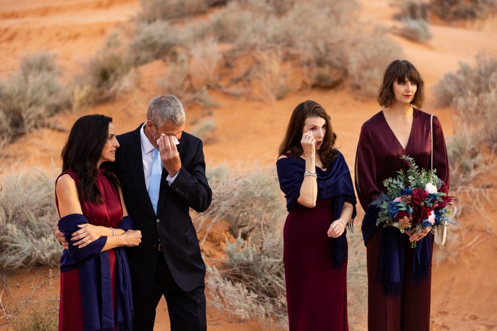Both parents are emotional as they witness the elopement ceremony of their kids.