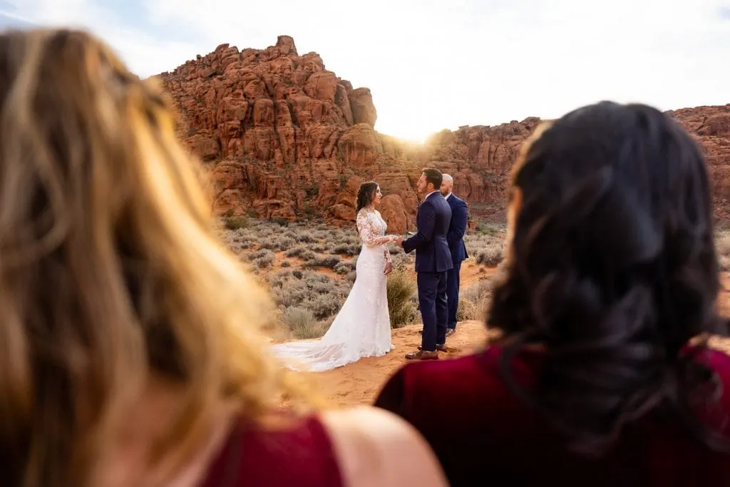Elopement photos in Snow Canyon state park where the couple gets married on the sand dunes.