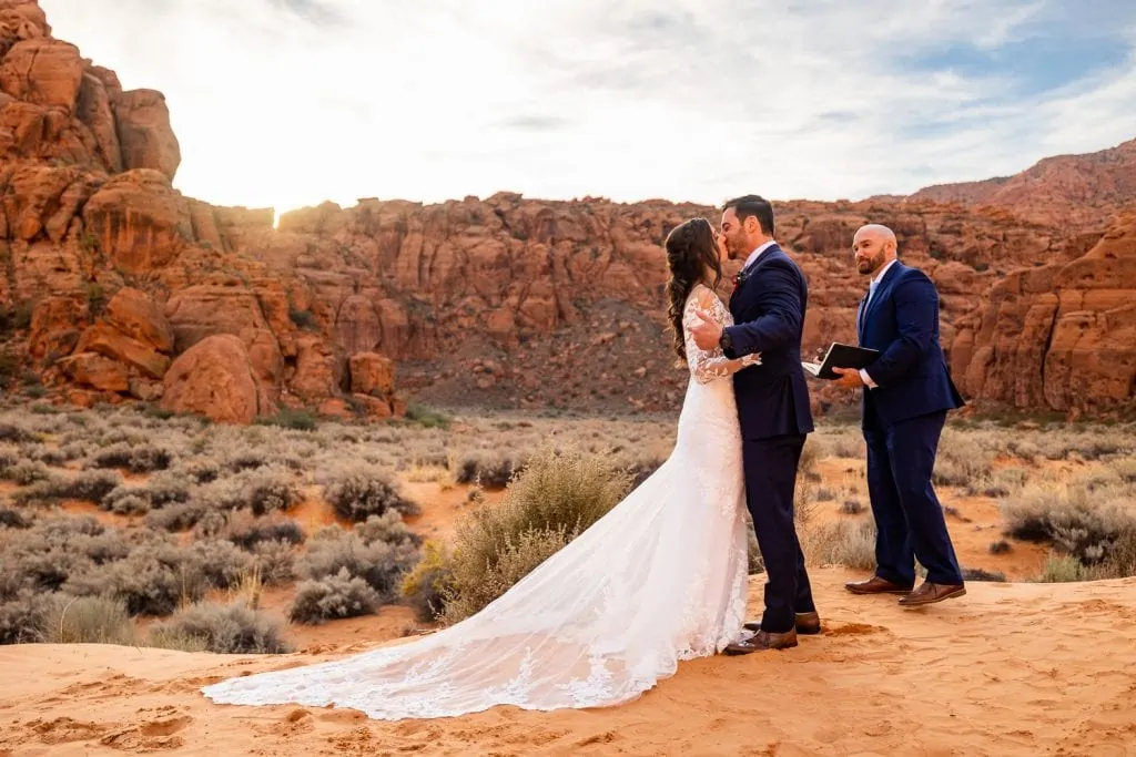 The first kiss of the elopement couple in Snow Canyon, Utah. 