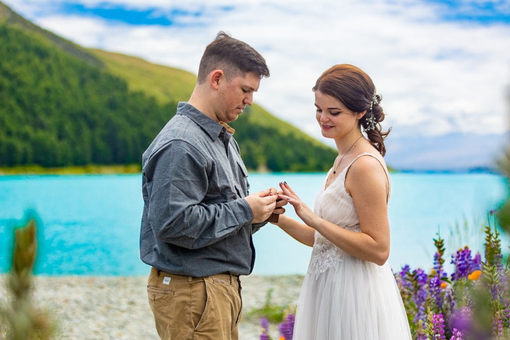 The wedding couple exchanges rings during their adventure elopement in New Zealand. 