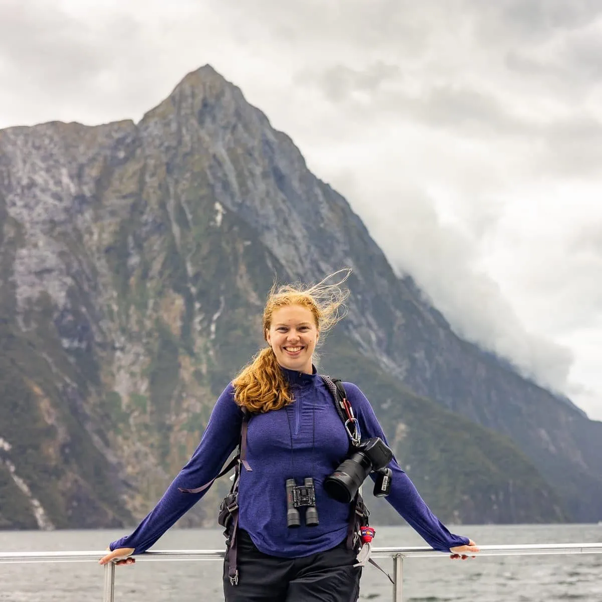 National park adventure elopement photographer Lucy Schultz on a boat in a fjord. 