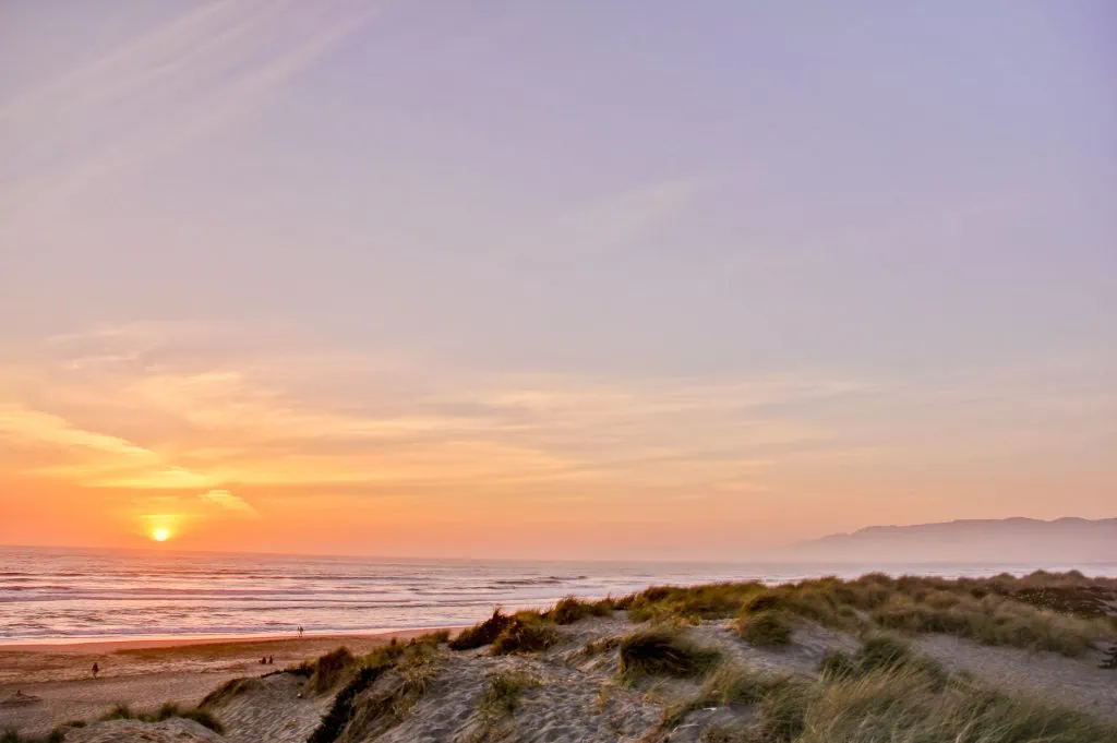A colorful sunset photo of Ocean Beach in San Francisco, California.