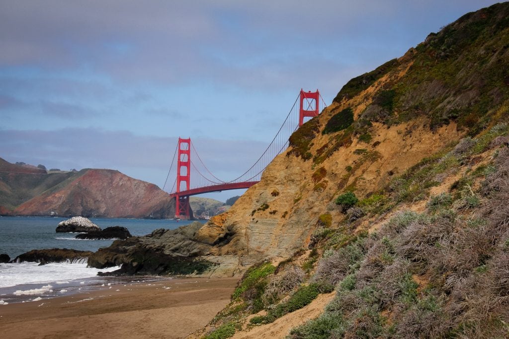A colorful photo of Golden Gate Bridge from the west coast beach in San Francisco, California.