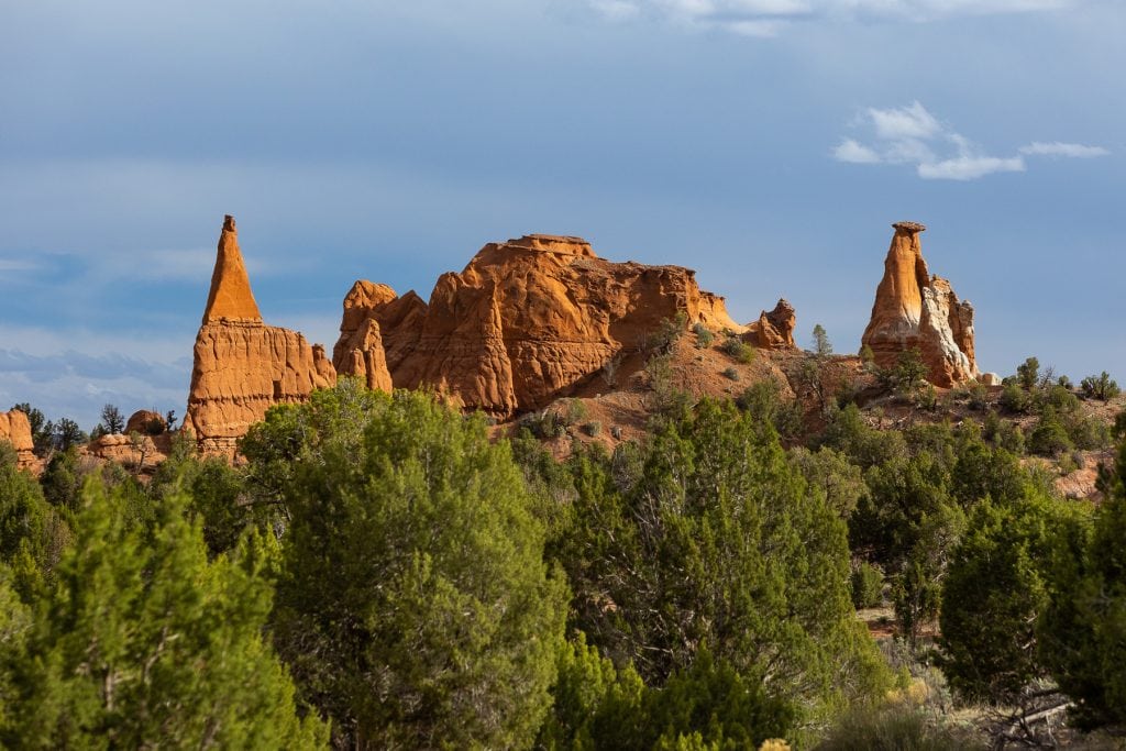 Red rock towers are visible over green forests at Kodachrome Basin in central Utah, making it a scenic state park elopement location.
