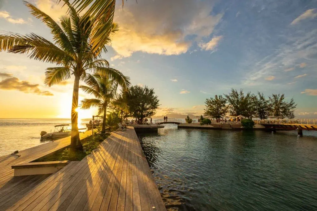Sunset over a fancy resort in Tahiti, French Polynesia by tahiti elopement photographer Lucy Schultz.
